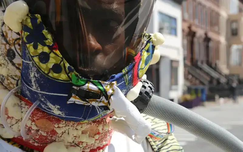 Ayodamola Okunsiende dressed as “the Afronaut on expedition”